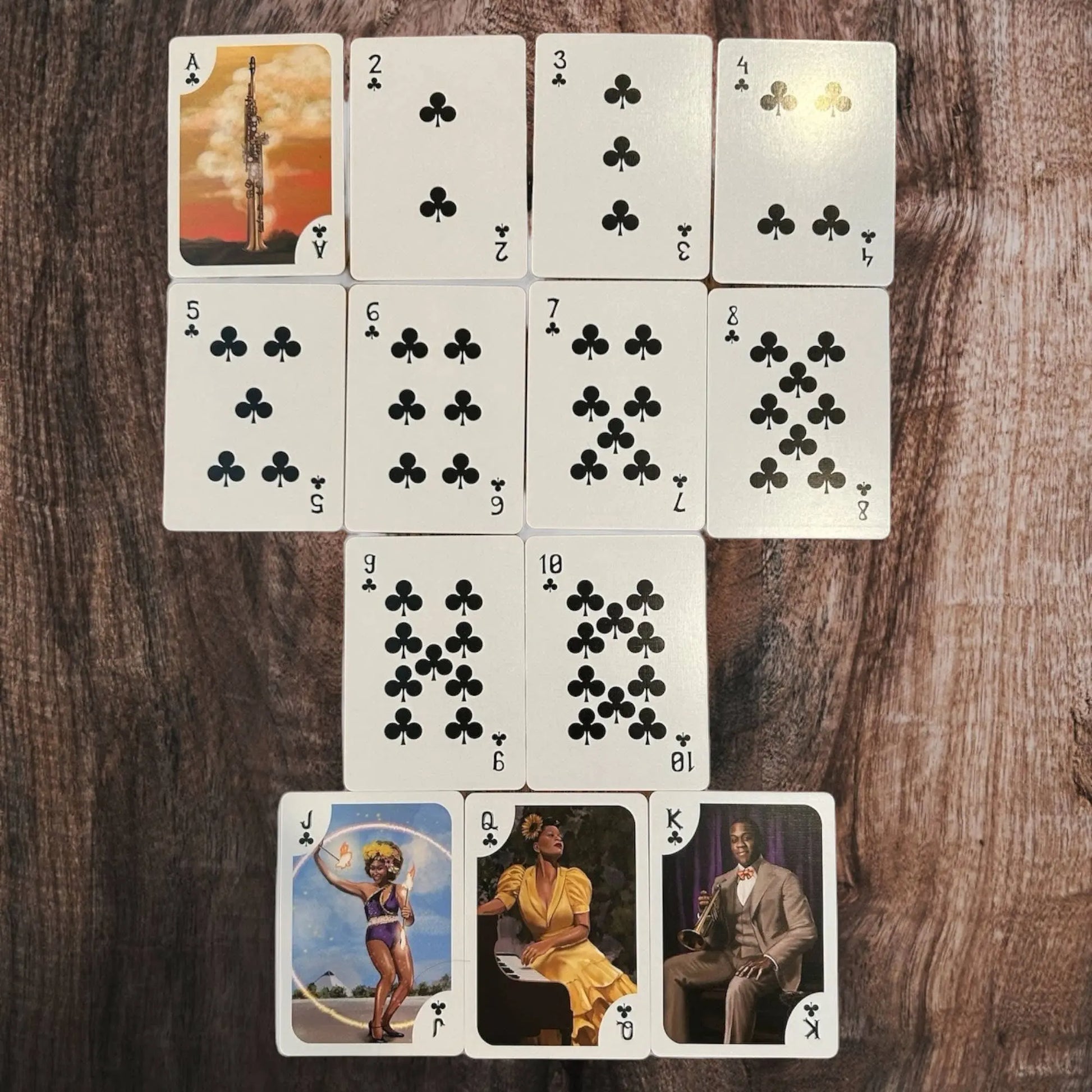 Set of playing cards with various designs on a wooden surface