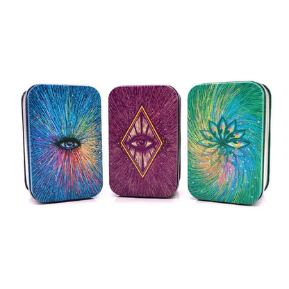 Three colorful tin boxes with abstract designs on a white background