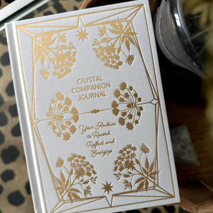 Crystal Companion Journal with gold floral designs on a white background Crystal companion journal by Bouchette and Co available from Oneness Emporium