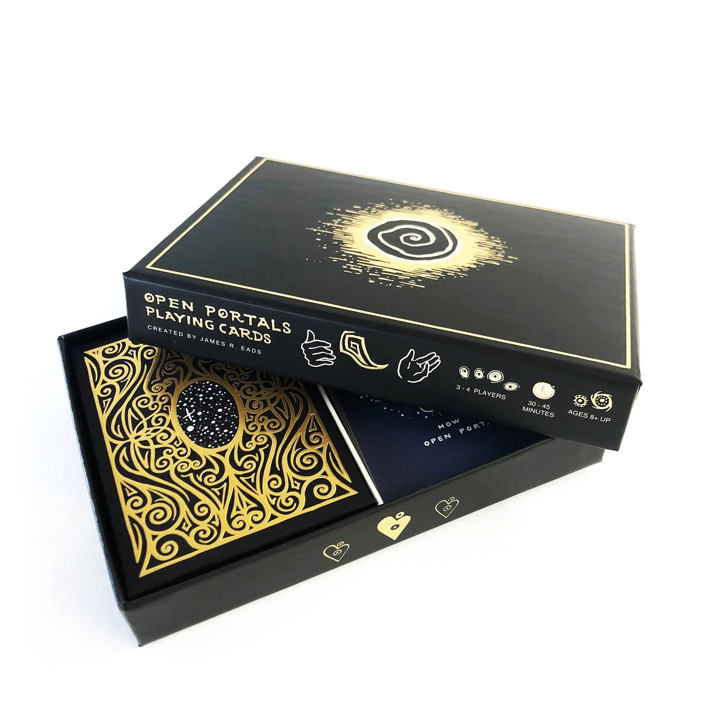Black and gold playing card box with decorative design on a white background
