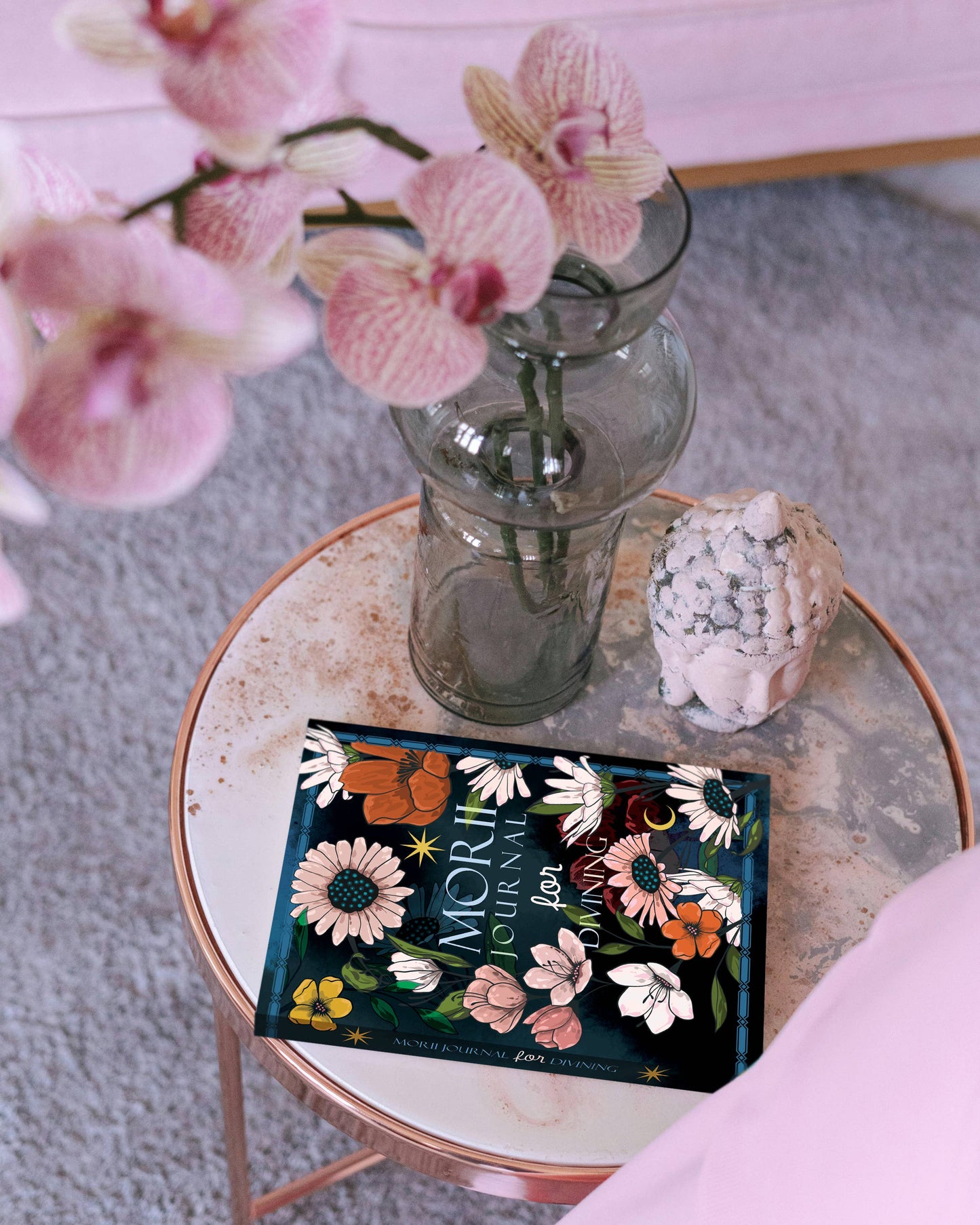 Moriori tea box with pink orchids on a small round table
