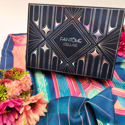 Fantom Deluxe makeup palette on a colorful fabric background with flowers