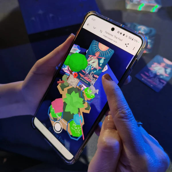 Person holding a smartphone with a colorful app interface on a dark surface