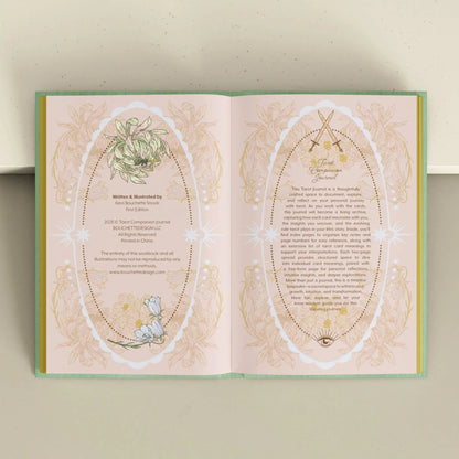 Open book with decorative pages featuring text and illustrations on a light background Tarot Journal Bouchette and Co Oneness Emporium