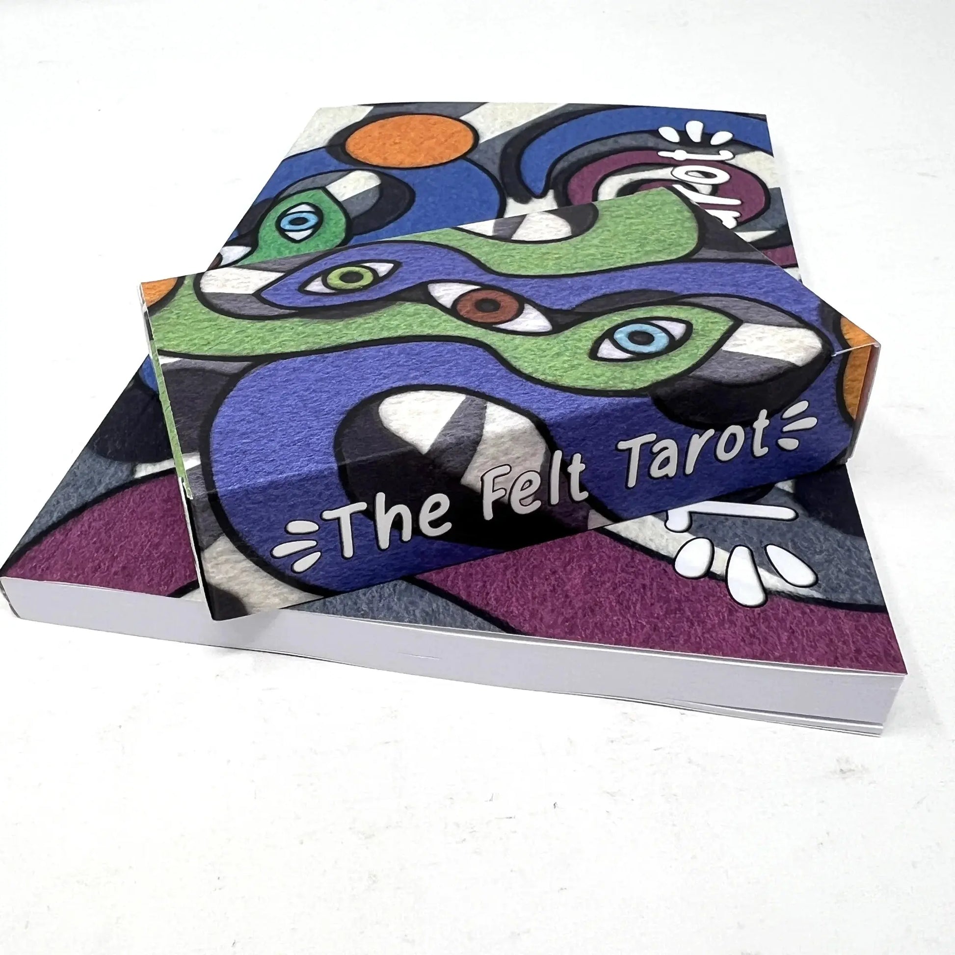 Box of 'The Felt Tarot' with abstract design on a white background
