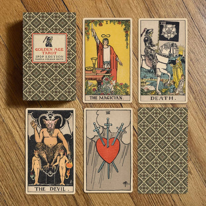 Collection of tarot cards and their packaging on a wooden surface