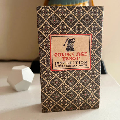 Book titled 'Golden Age Tarot 1909 Edition' by Pamela Colman Smith on a surface.