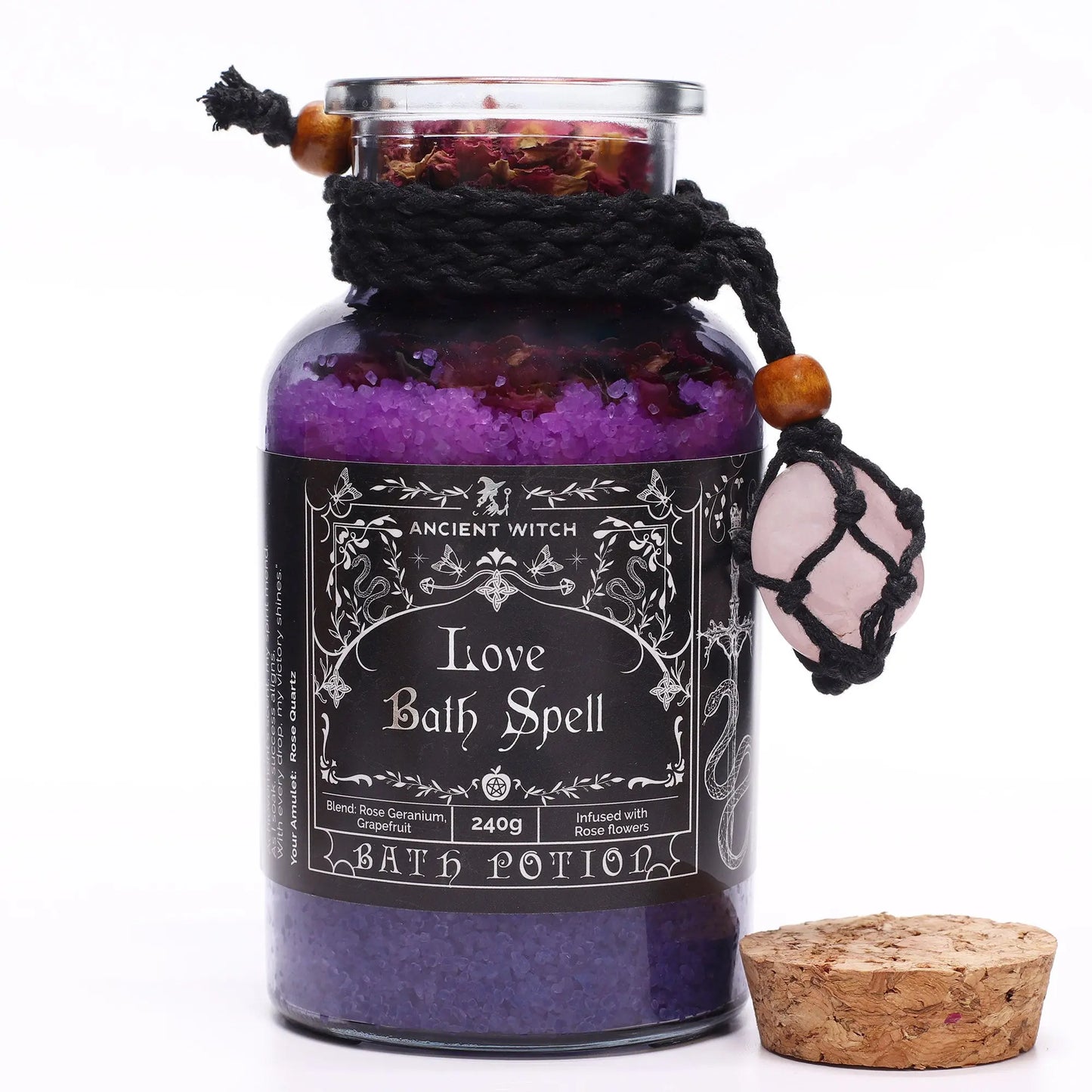 Bottle labeled 'Love Bath Spell' with a black label and cork lid on a white background