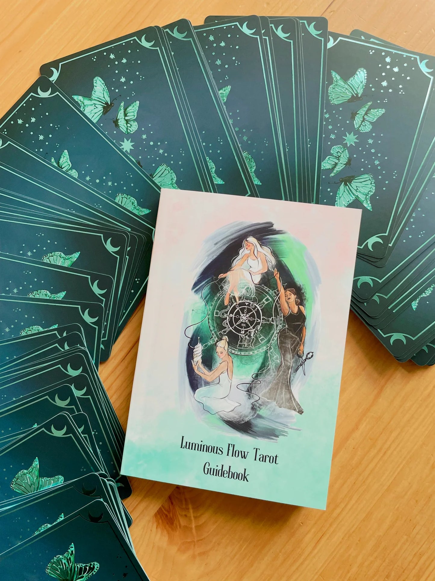 Luminous Flow Tarot first edition deck with watercolor artwork and gold detailed box.