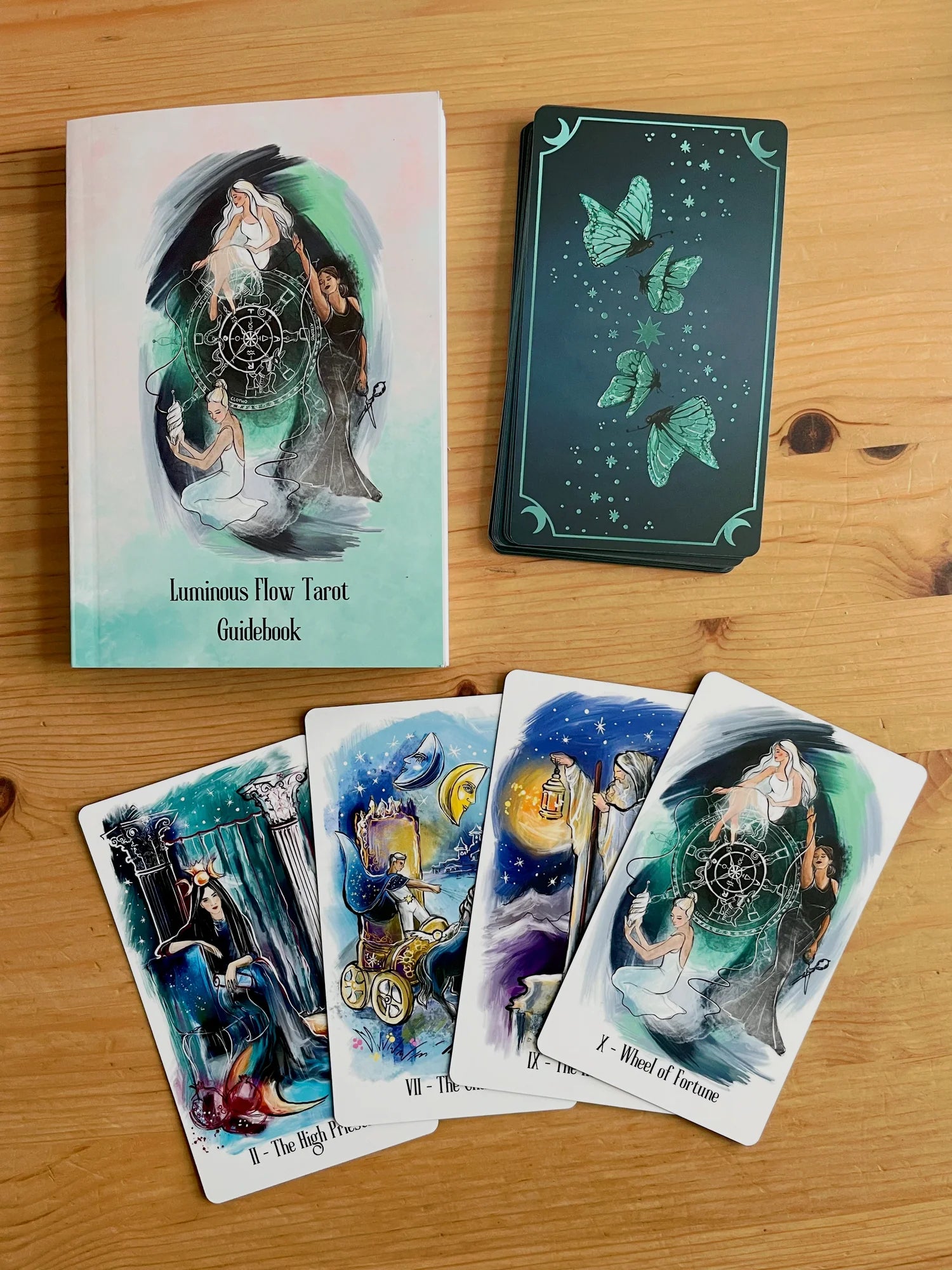 Luminous Flow Tarot first edition deck with watercolor artwork and gold detailed box.