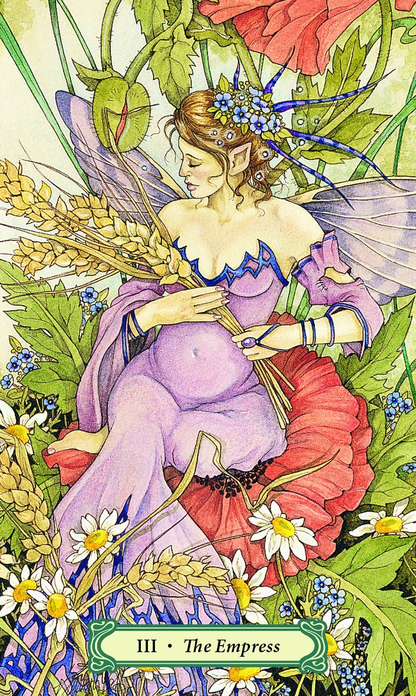 Mystic Faerie Tarot deck by Linda Ravenscroft featuring whimsical faerie themed tarot artwork. Colorful illustration of a fairy surrounded by flowers and plants, with 'The Empress' card text at the bottom.