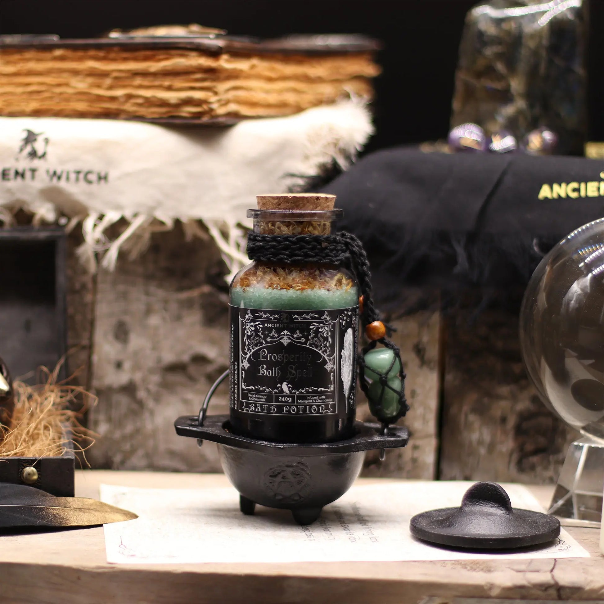 Bottle labeled 'Bath' on a rustic wooden surface with witchcraft-themed decor.