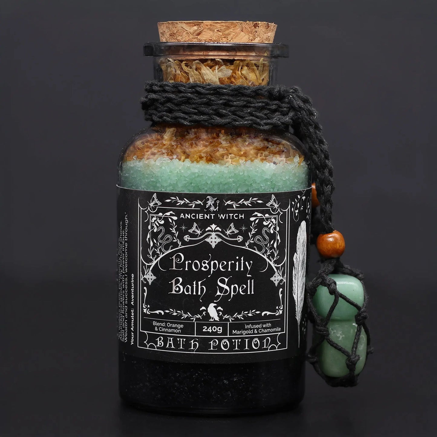 Bottle of 'Prosperity Bath Spell' with decorative elements on a dark background