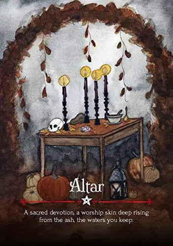 An arch made from autumn leaved with a wooden table carrying candles and skulls 