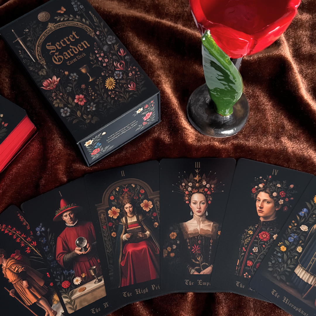 Playing cards with artistic illustrations on a brown fabric background