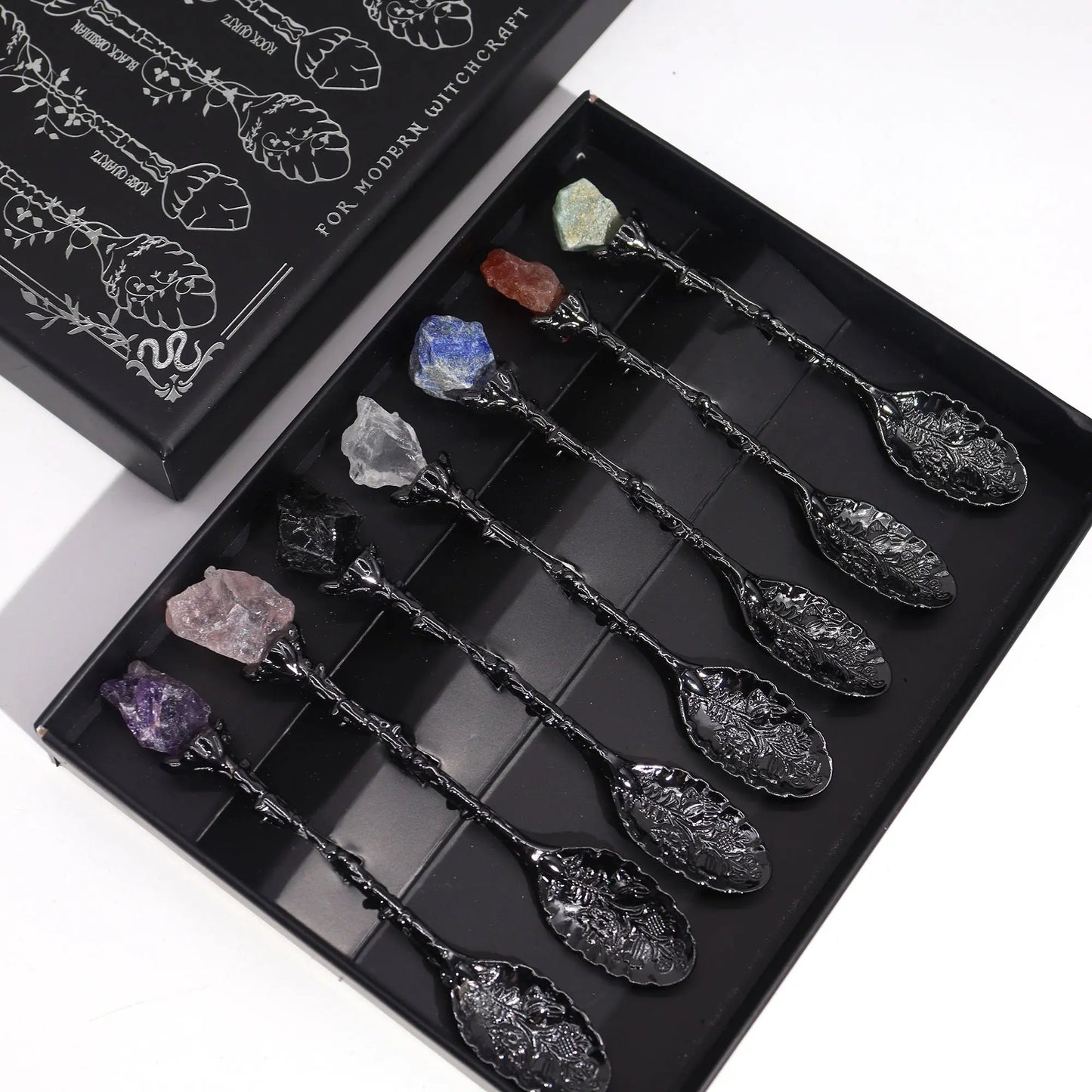 Set of decorative spoons with crystals in a black box