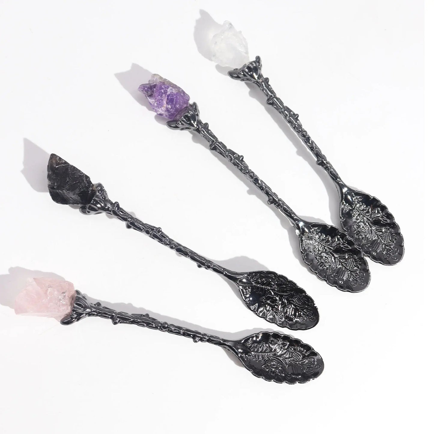 Decorative spoons with crystal handles on a white background