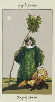 The king of wands tarot card is depicting wearing a gown made from leaves and holding a long brand full of foliage. At his feet lays his companion in the form of a yellow dragon 