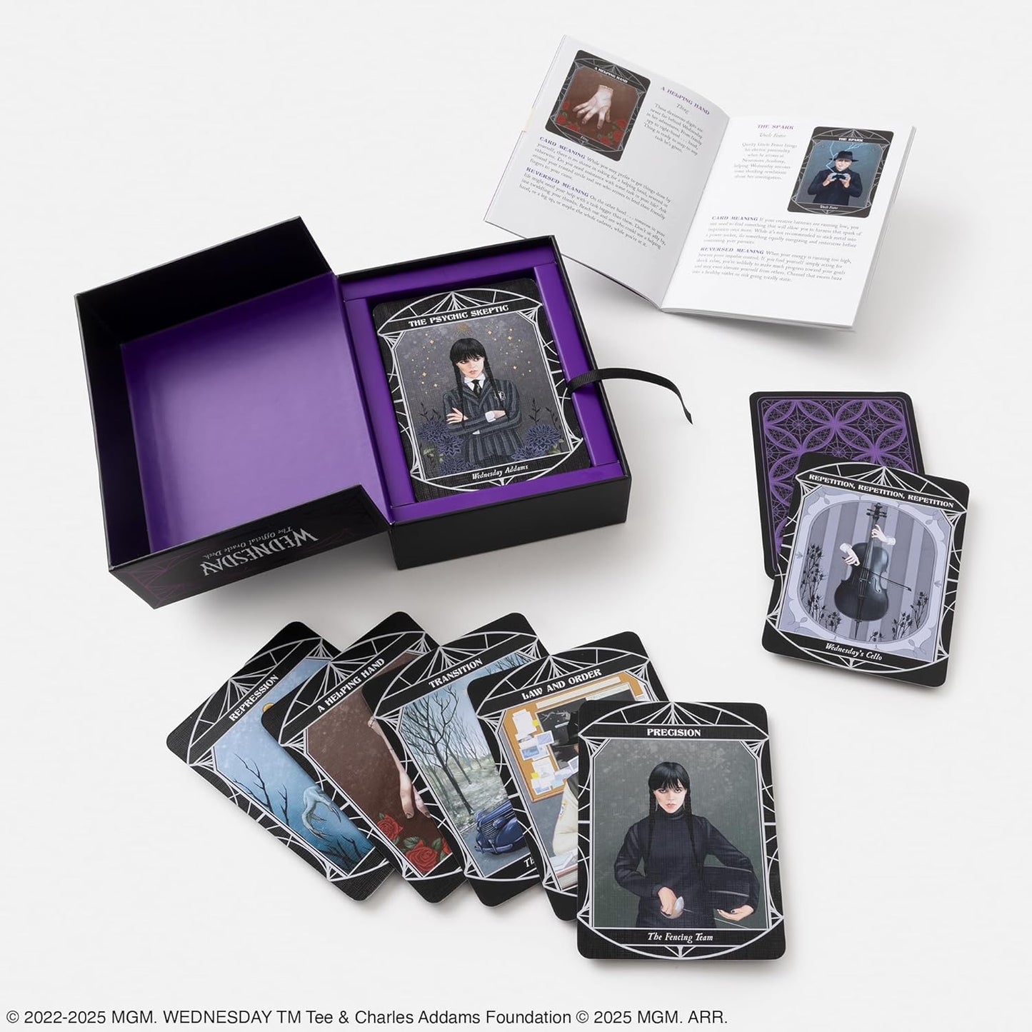 Set of tarot cards with a purple box and instruction manual on a white background Netflix TV show Wednesday 