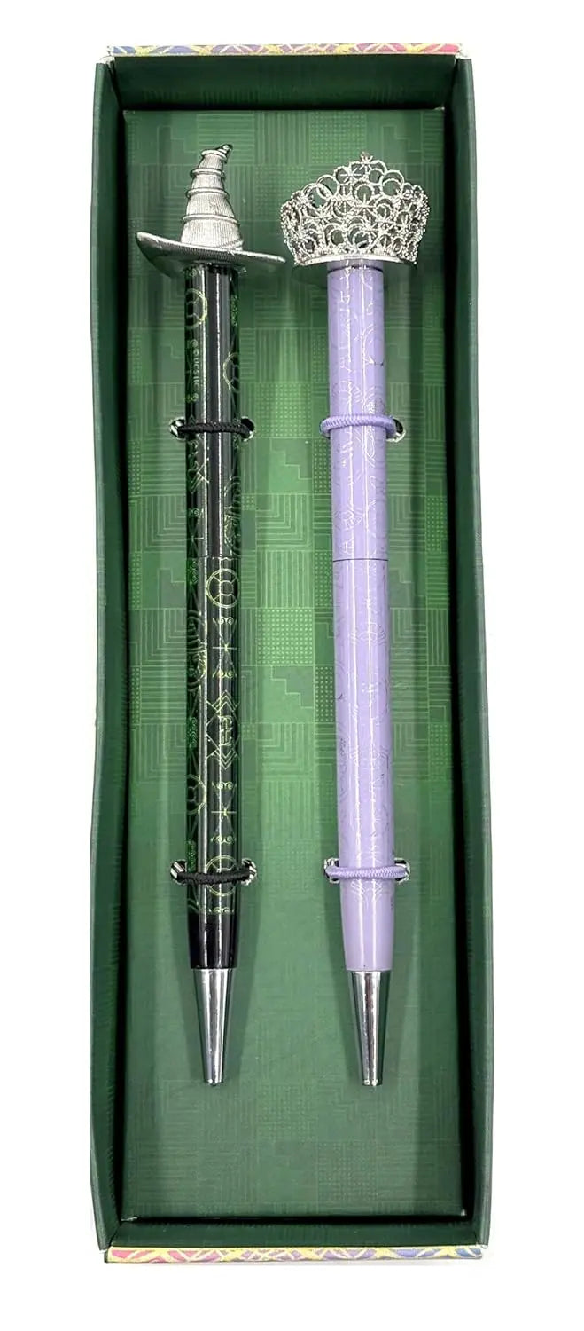Decorative pen and pencil set with silver accents in a green box Purple pen with decorative top in a green box labeled Wicked movie official merchandise Elphaba and Glinda pens Oneness Emporium